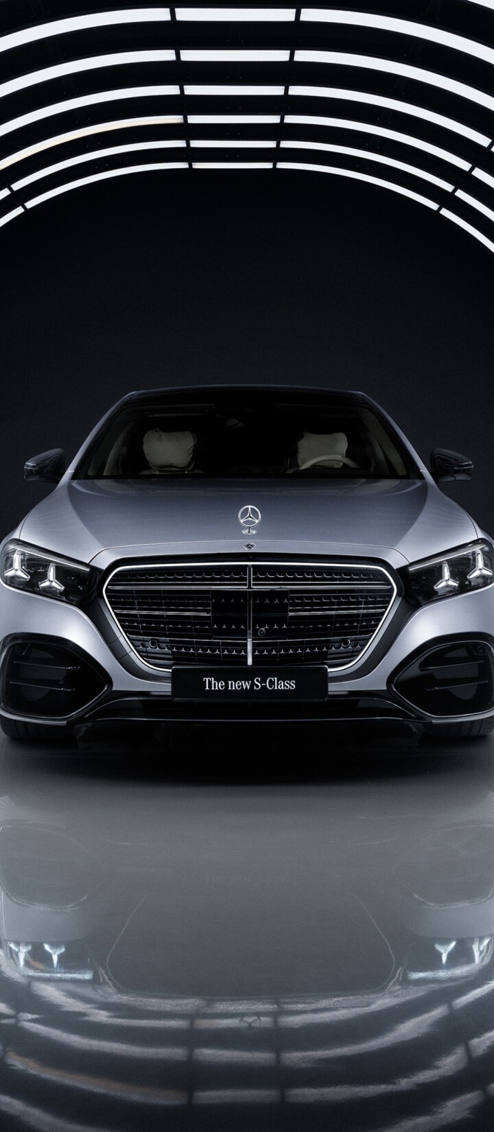 A sleek 2026 Mercedes-Benz S 580 e 4MATIC luxury sedan illuminated by sharp LED lighting against a dark, minimalist background.
