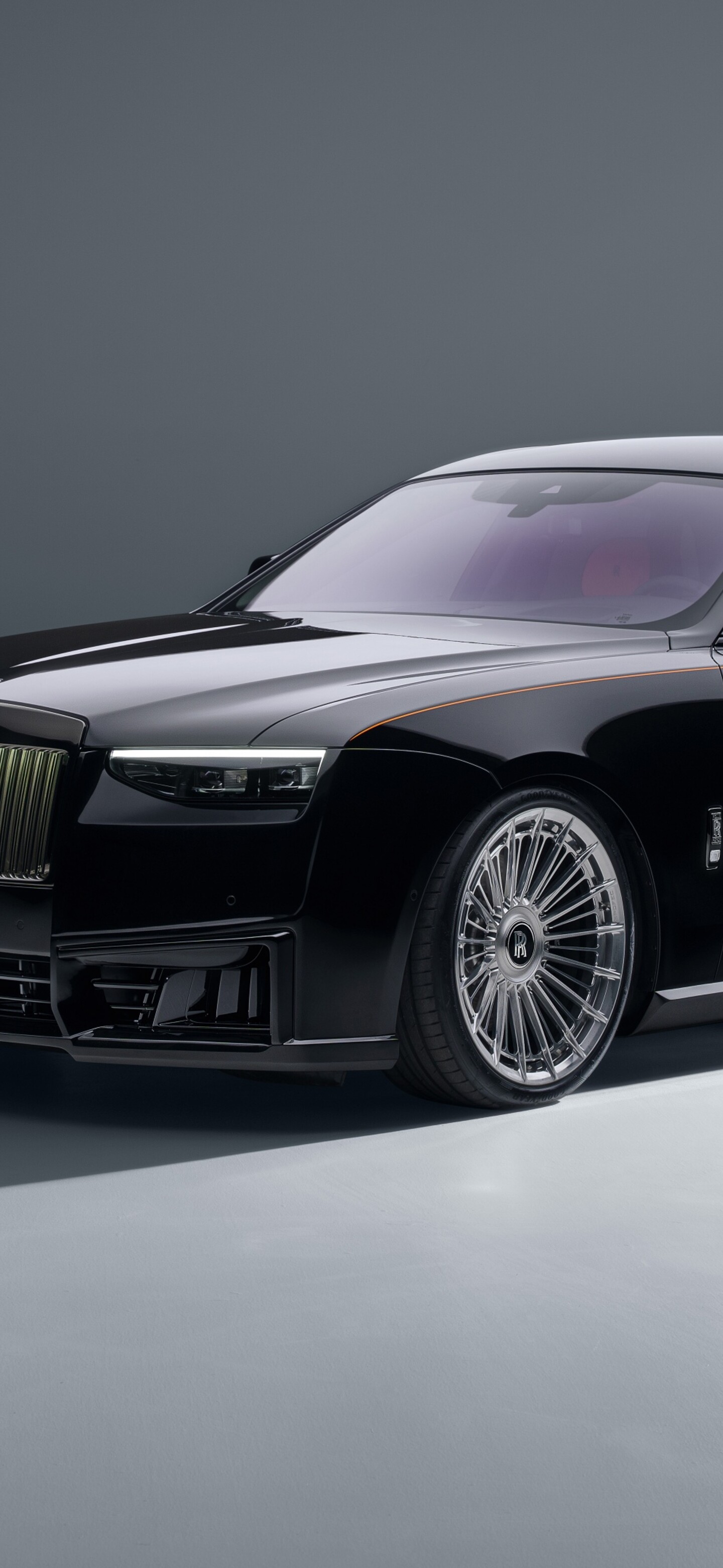 A high-resolution, cinematic close-up of the 2026 Rolls-Royce Black Badge Ghost featuring a dark, luxurious exterior.