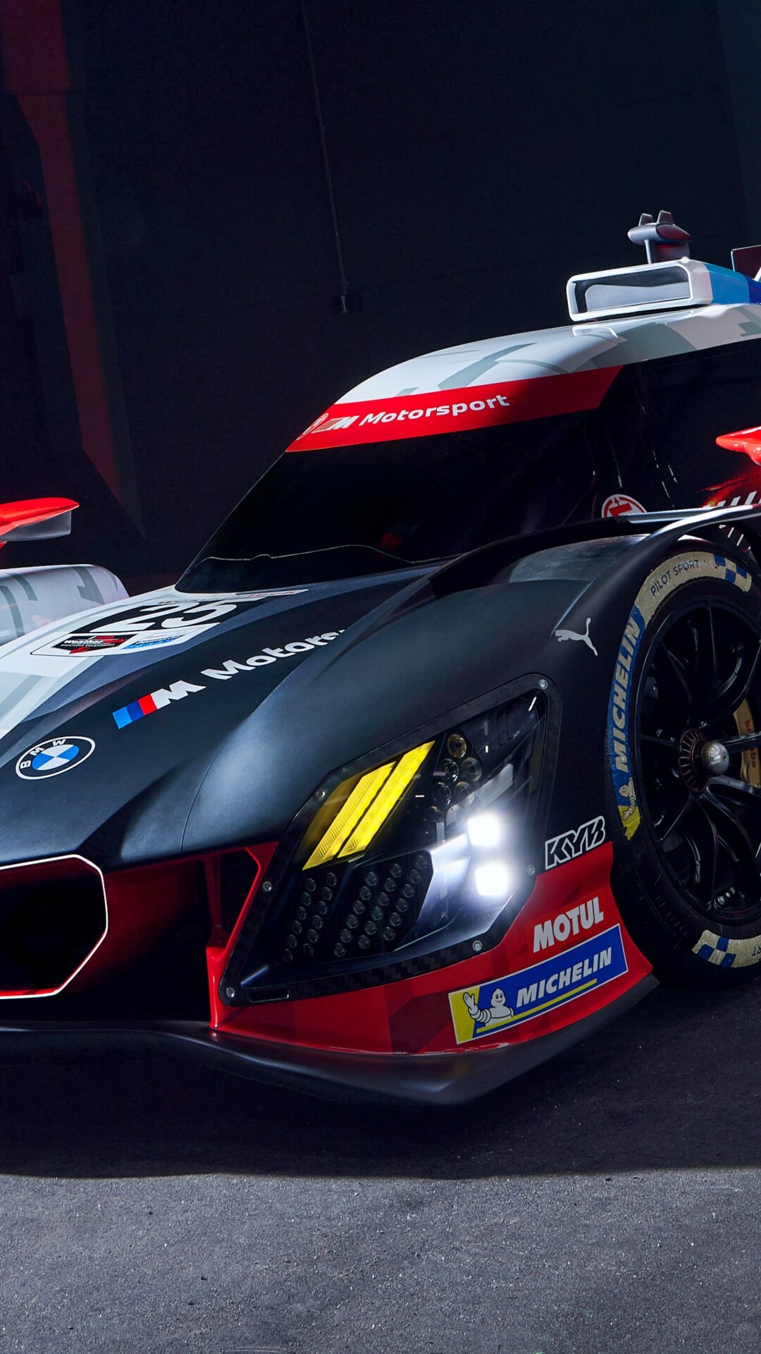 A futuristic BMW M Hybrid V8 racing car featuring aerodynamic bodywork and a high-speed racing aesthetic.