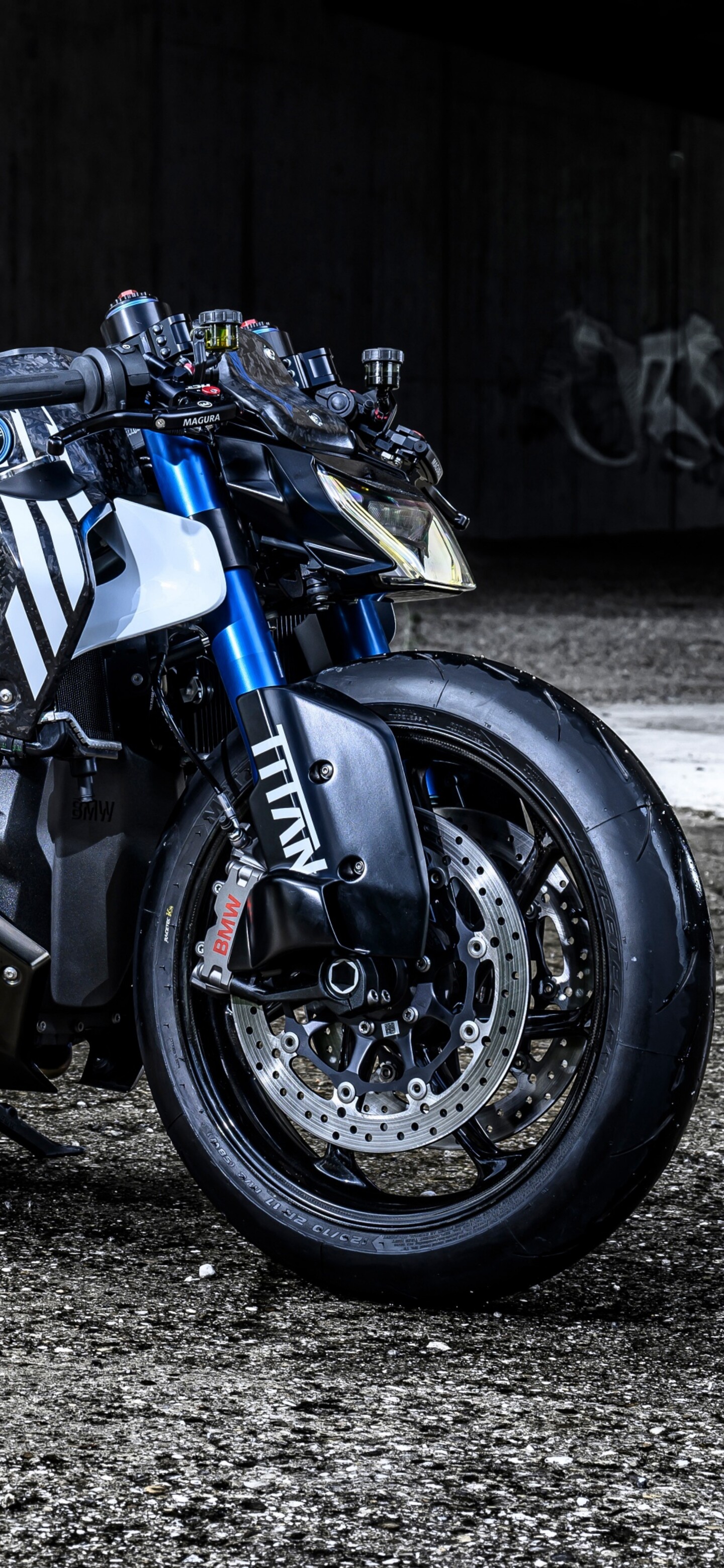A custom 2025 BMW R 1300 R Titan motorcycle parked in front of a colorful graffiti-covered urban wall.