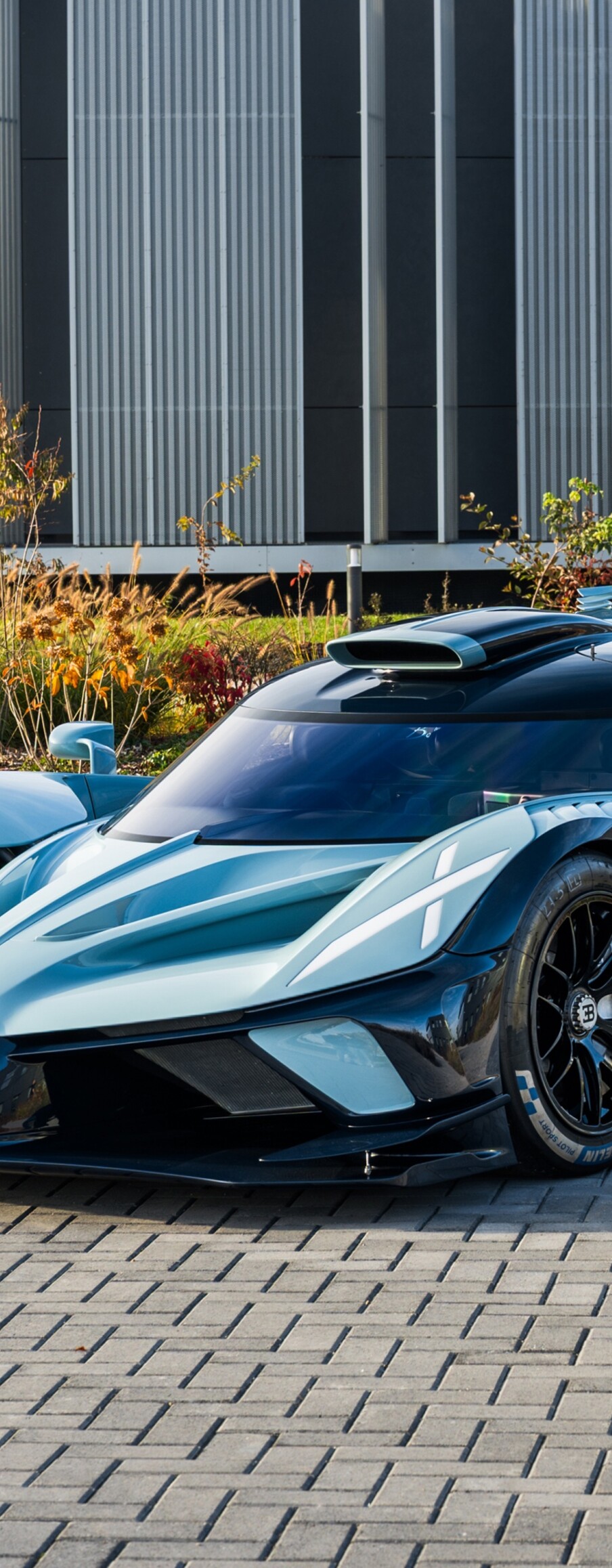 A high-resolution 5K shot of the Bugatti Bolide hypercar positioned on an outdoor racing track.