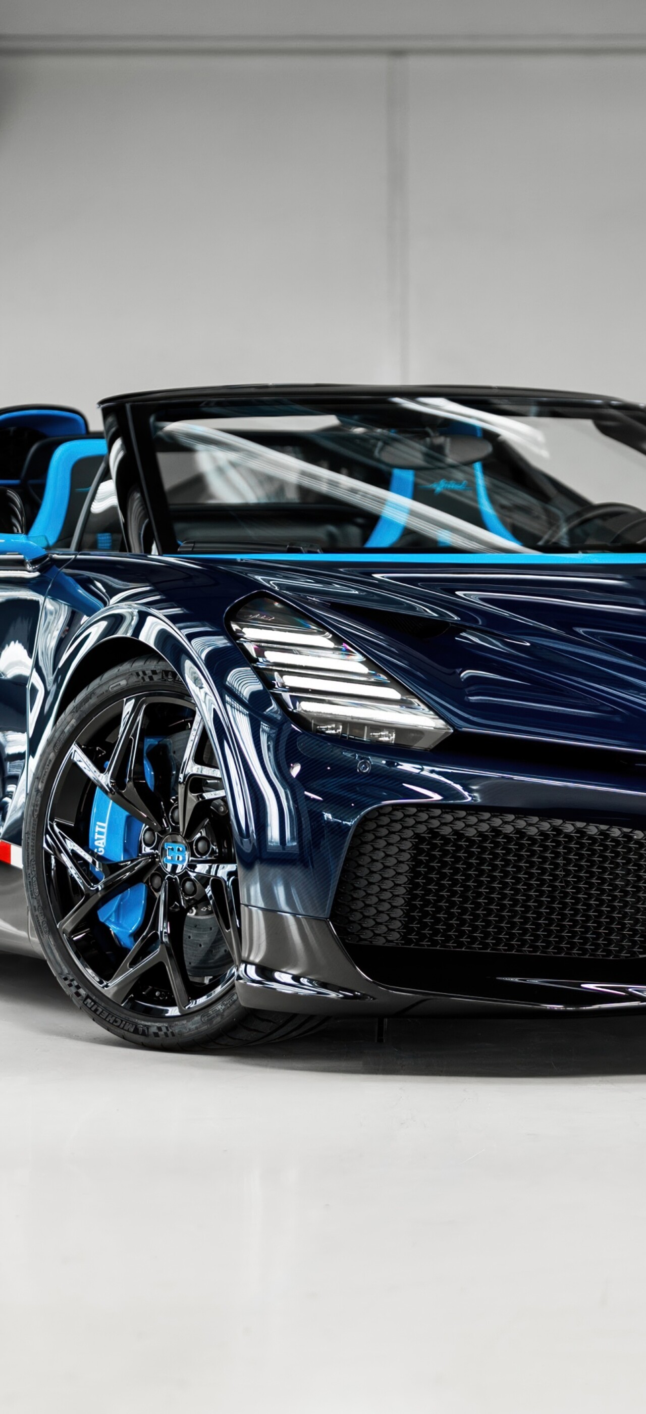 A high-performance Bugatti W16 Mistral sports car with a blue and black exterior.