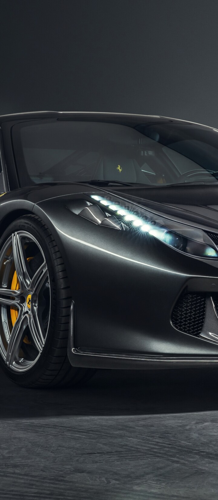 A close-up, high-resolution shot of a Ferrari 458 sports car showcasing intricate carbon fiber details and sleek automotive design.