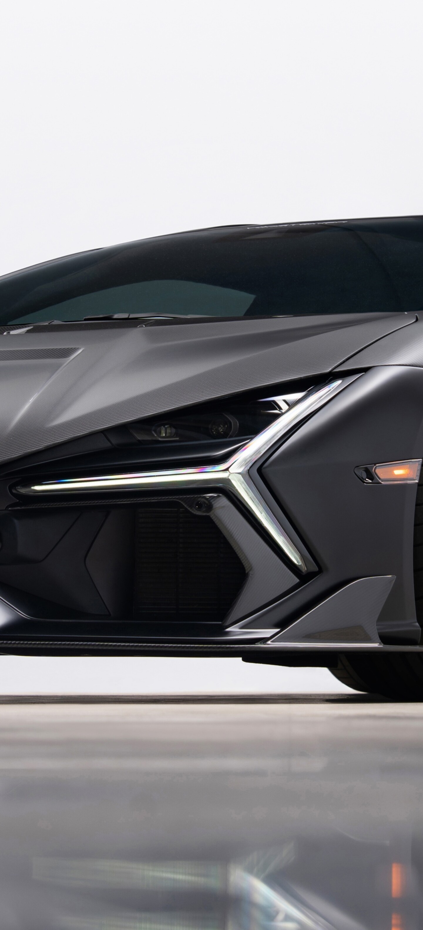Close-up detailed view of a Lamborghini Revuelto featuring a textured carbon fiber finish.