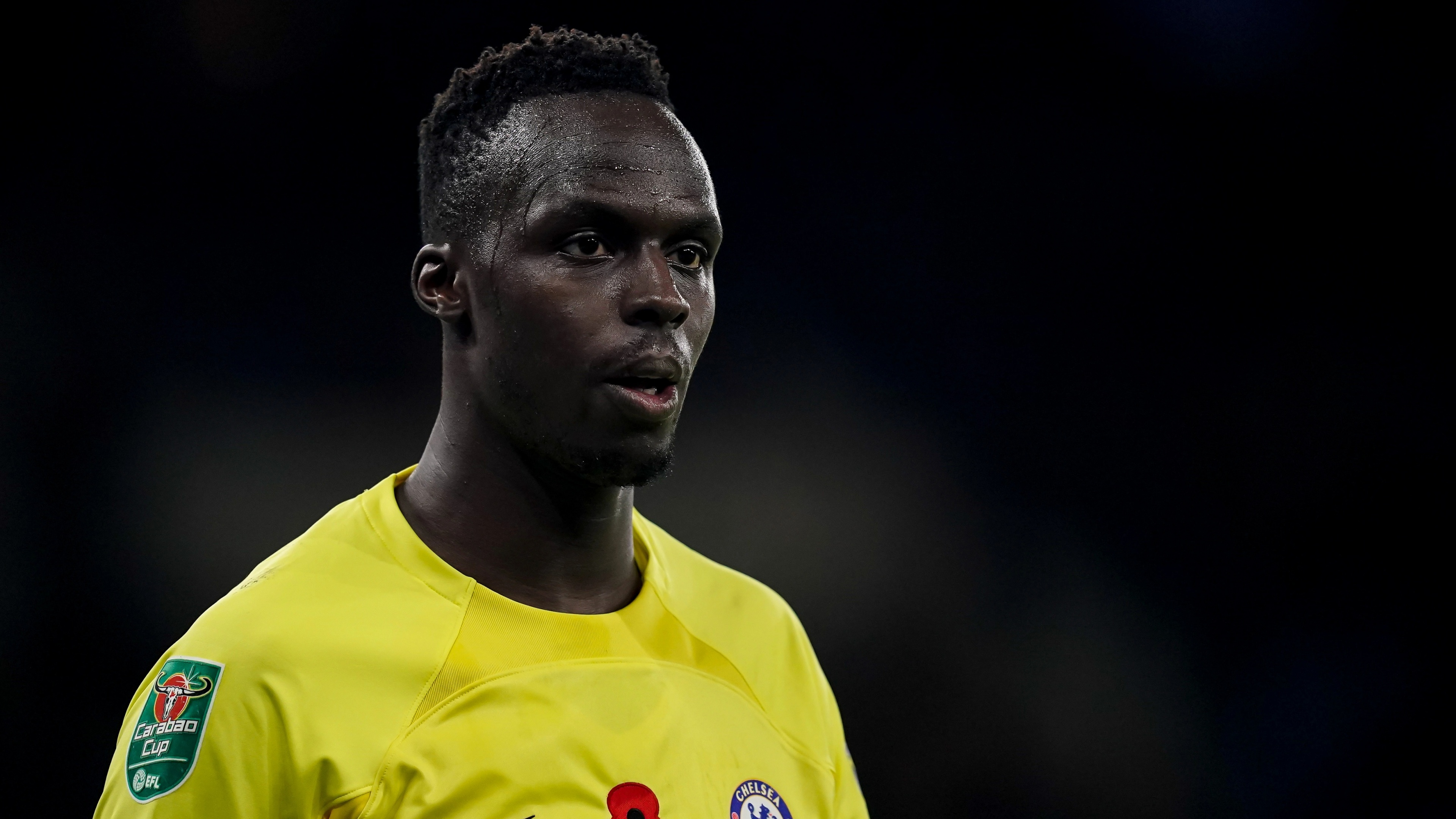 A football player dressed in the official blue Chelsea FC jersey.