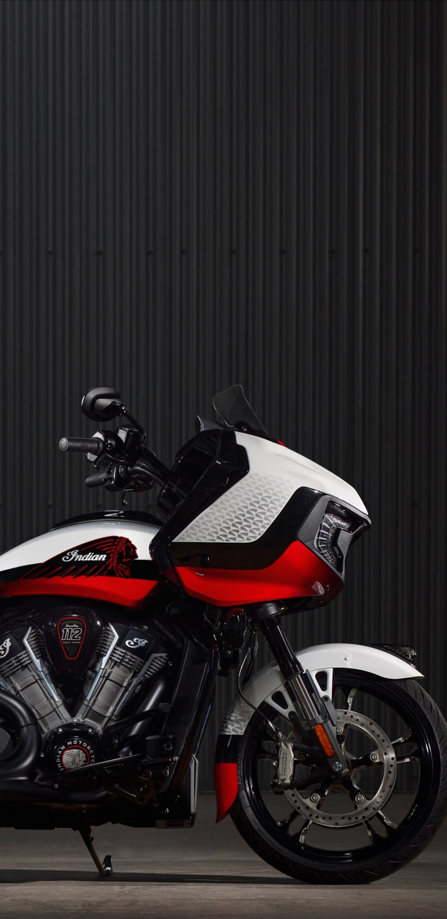 A high-resolution close-up of an Indian Chieftain Elite cruiser motorcycle featuring polished chrome and a dark, moody atmosphere.