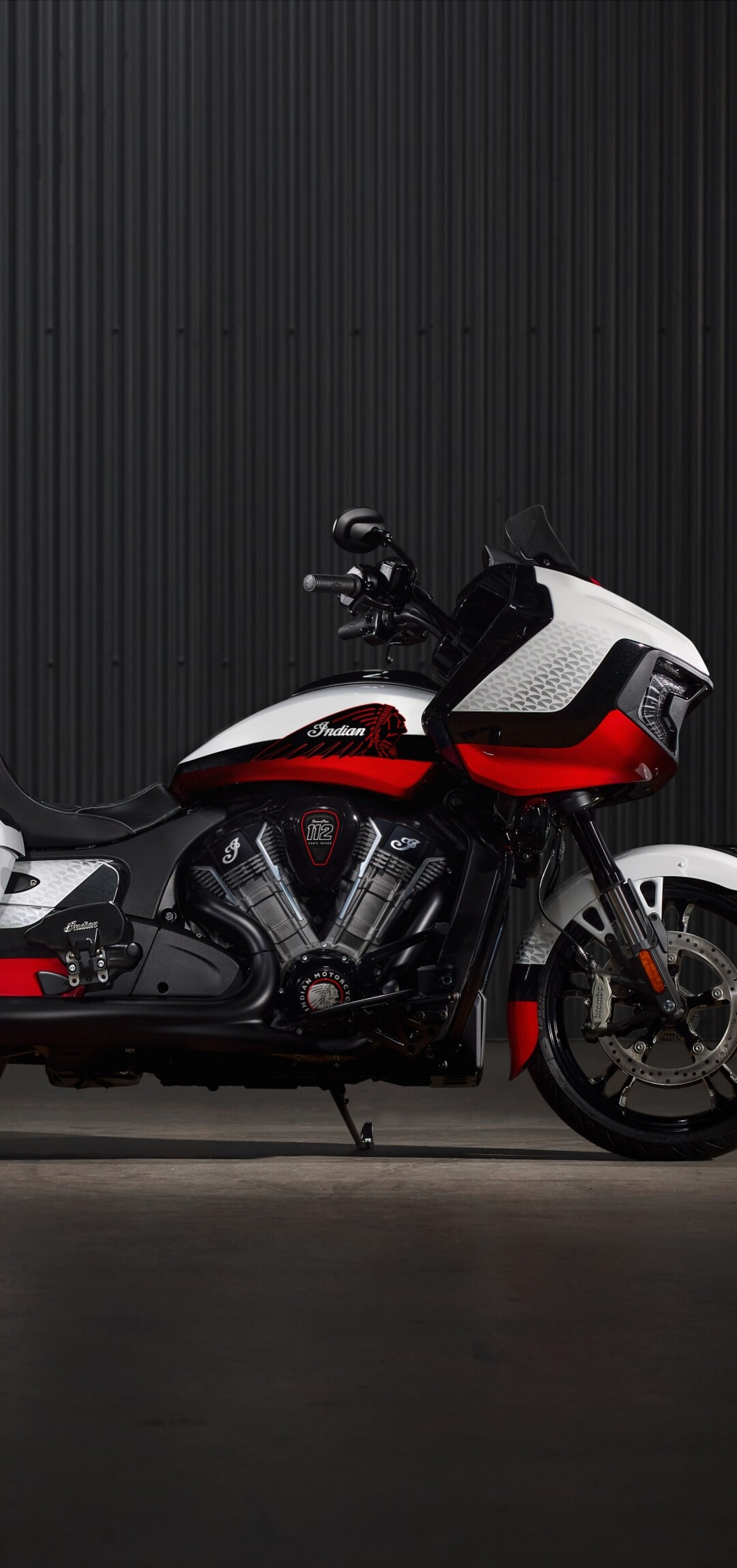 A high-resolution, cinematic shot of an Indian Chieftain Elite cruiser motorcycle against a dark, atmospheric background.