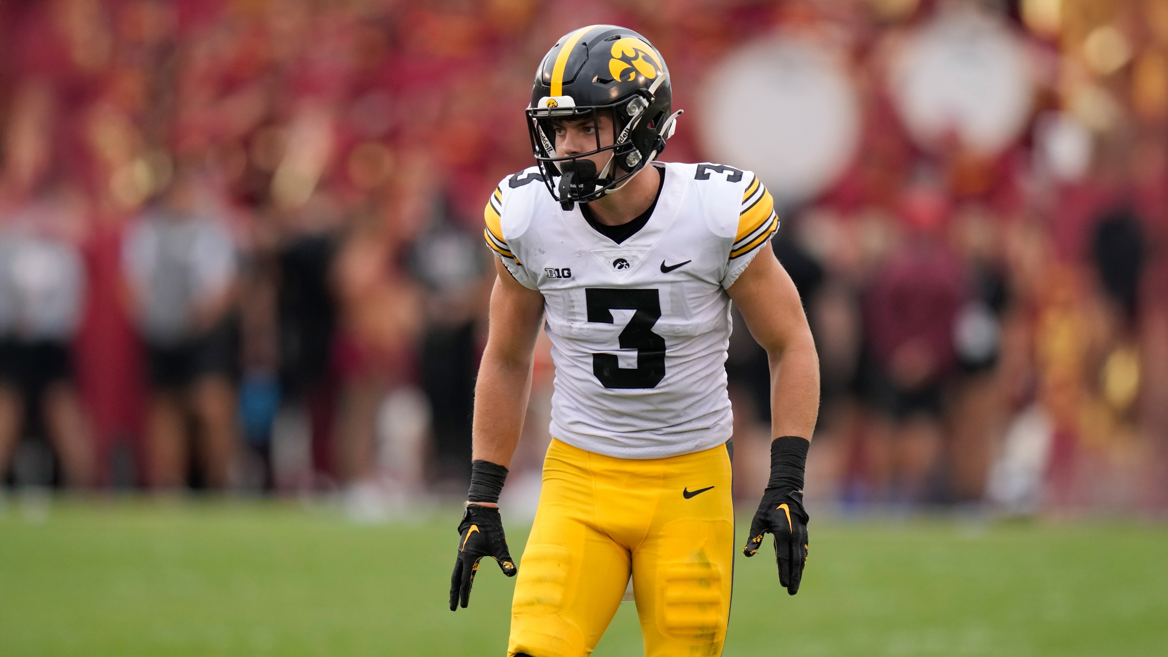 A high-resolution close-up portrait of American football player Cooper DeJean wearing an Iowa Hawkeyes uniform.