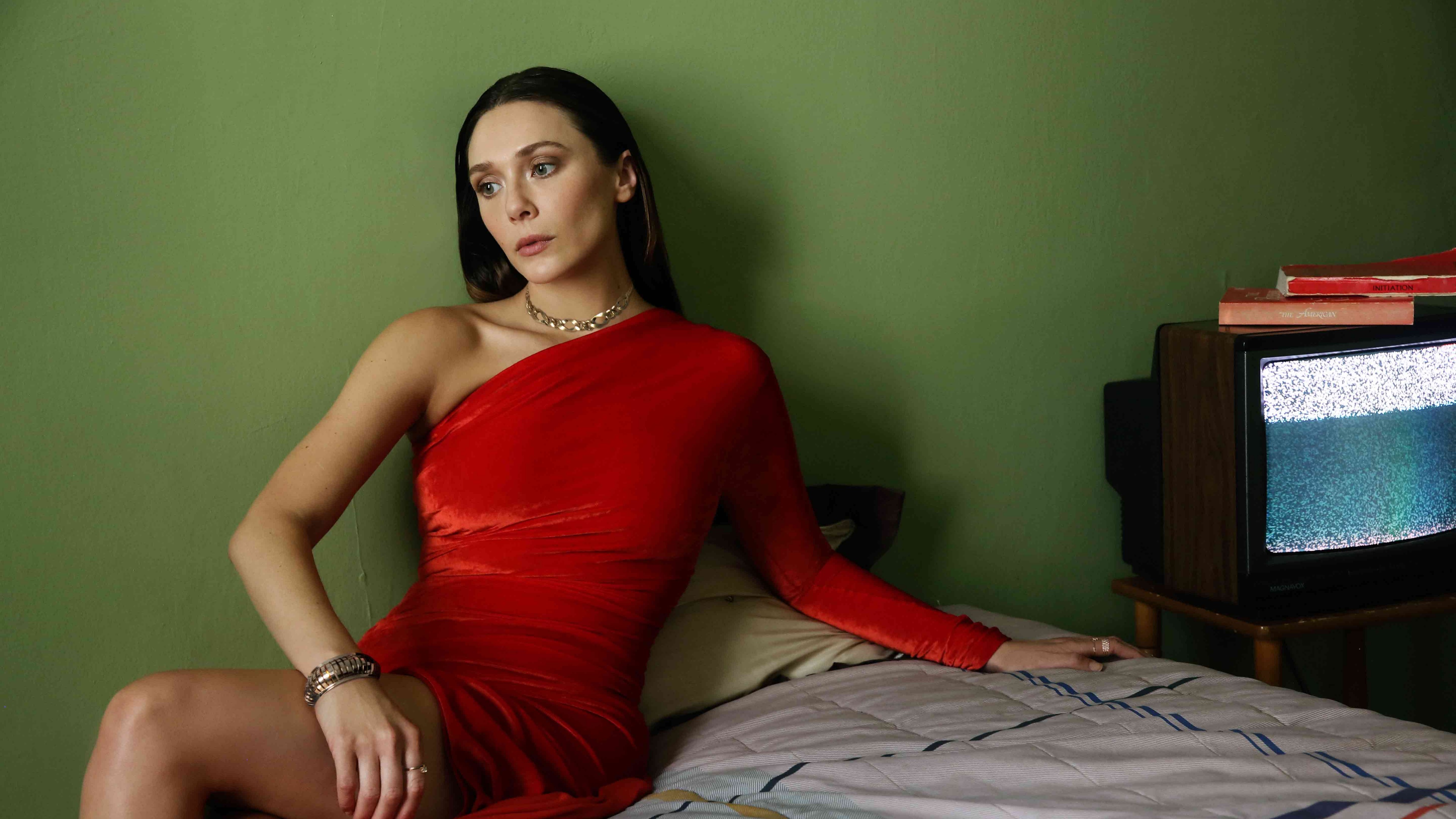 A beautiful portrait of actress Elizabeth Olsen wearing a luxurious red gown.