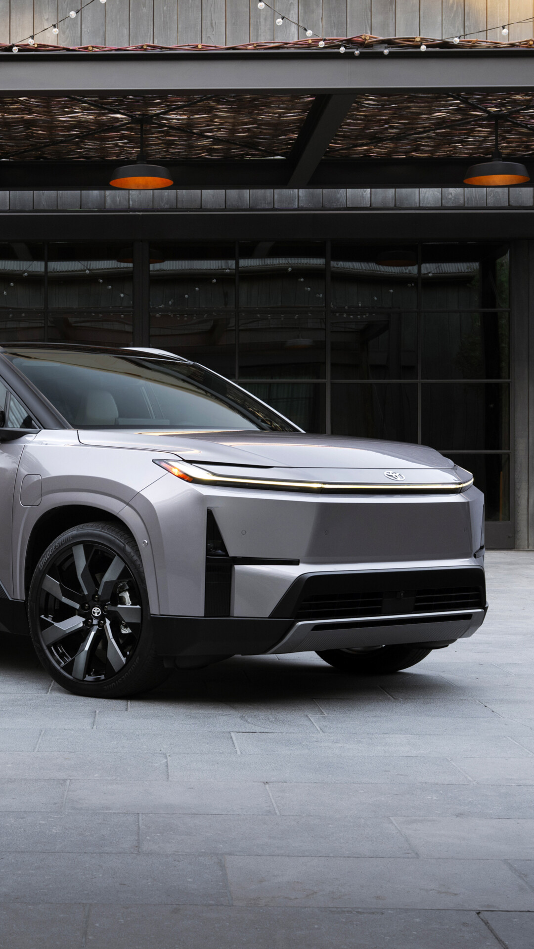 A futuristic electric SUV with a streamlined aerodynamic design and advanced LED headlights, representing 2027 automotive technology.