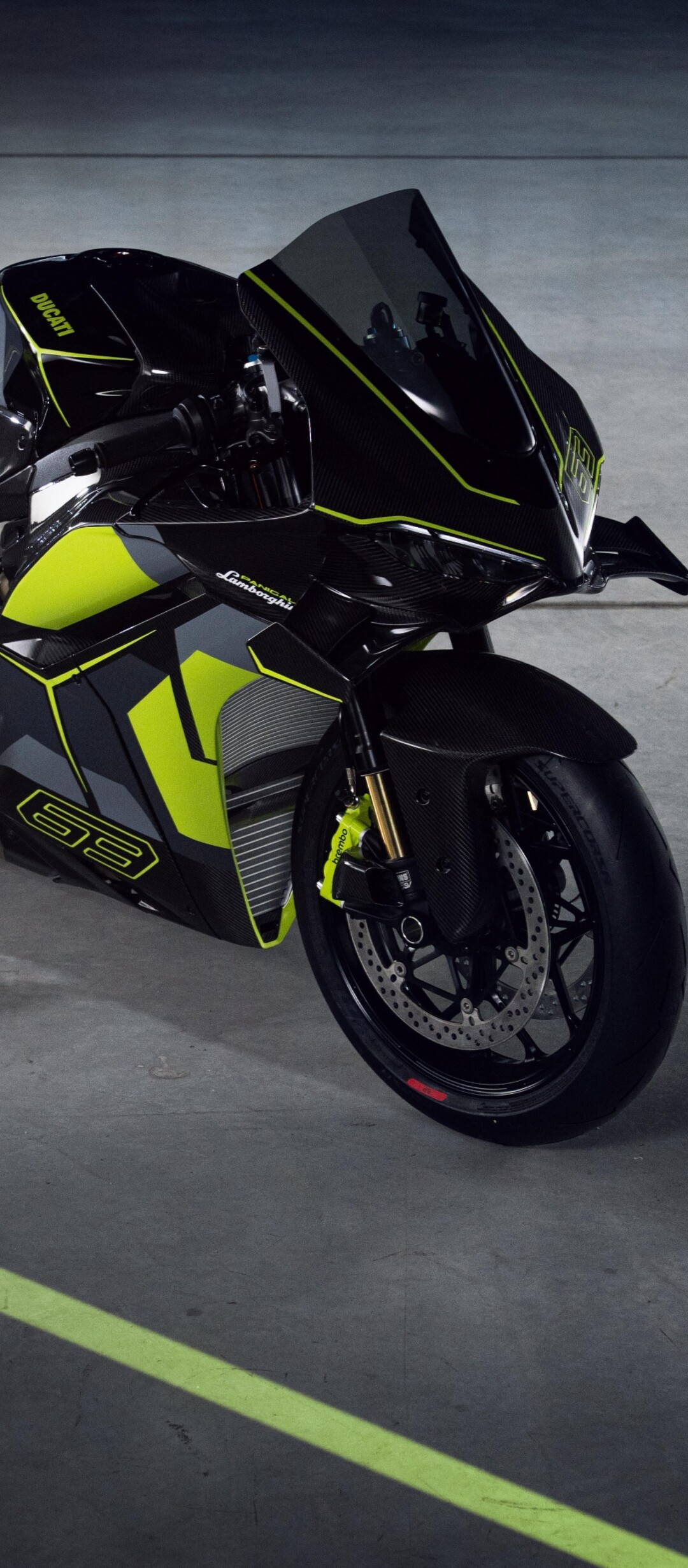A high-detail shot of a Lamborghini supercar and a Ducati Panigale V4 motorcycle presented in a dark, cinematic setting with dramatic lighting.