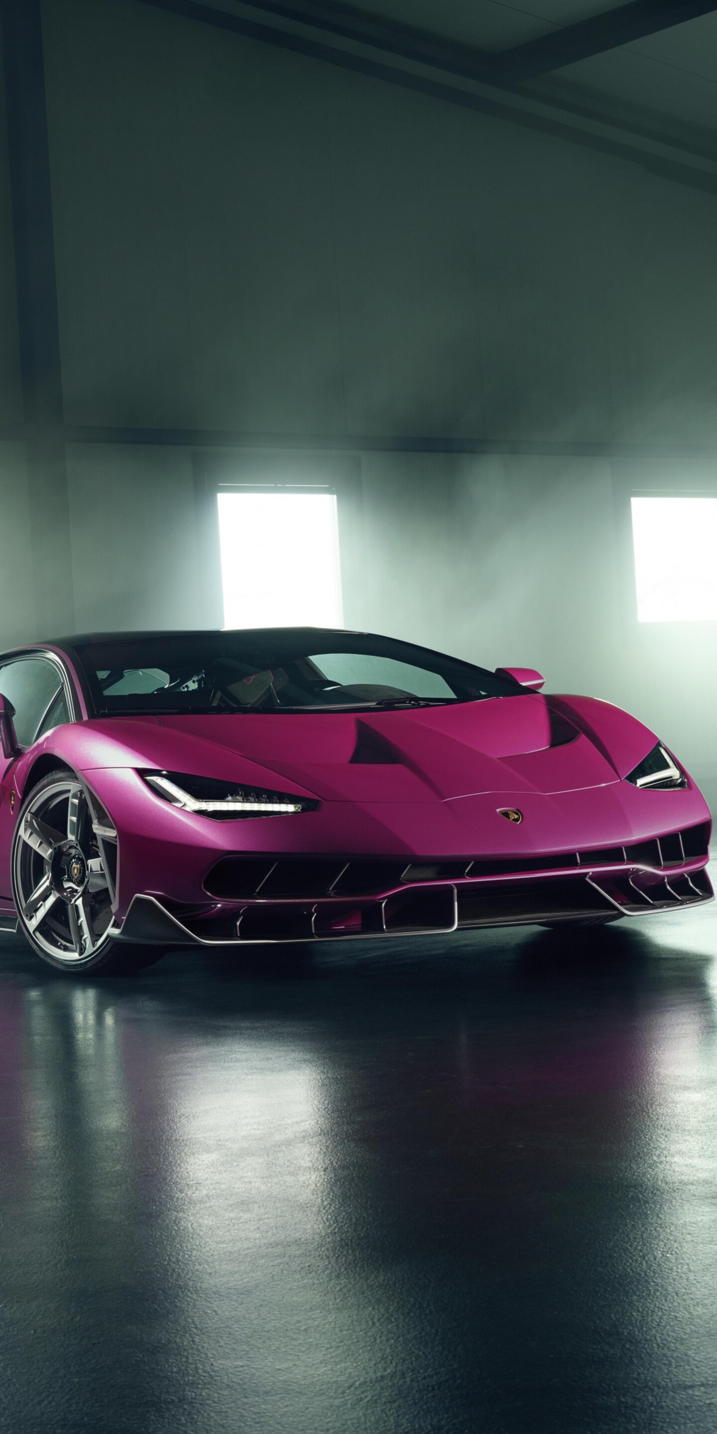 A detailed, high-resolution view of a Lamborghini Centenario parked in a modern, luxury garage setting.