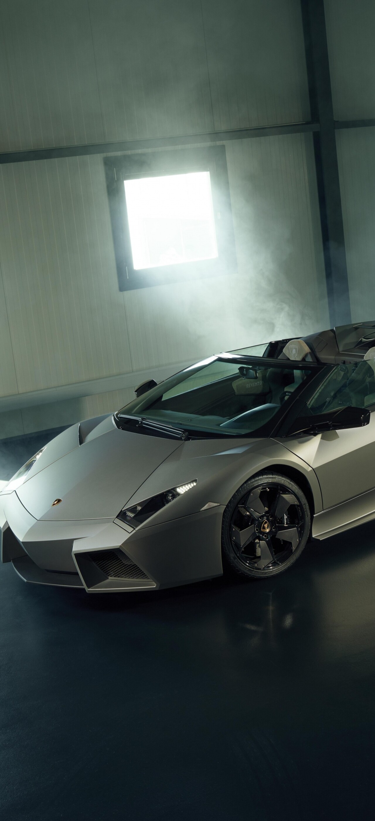 A high-detail, cinematic shot of a Lamborghini Reventon supercar parked inside a luxury modern garage.