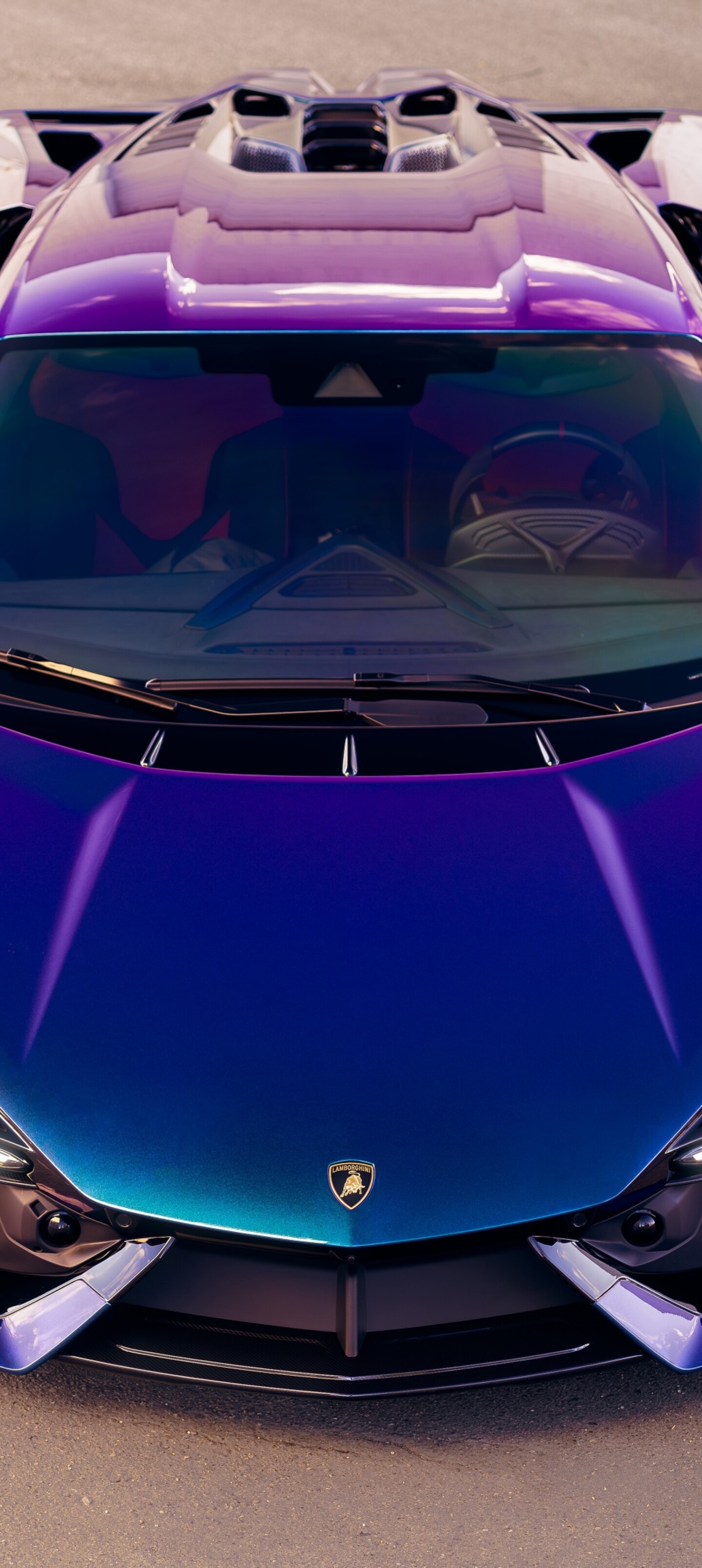 A high-resolution top-down view of a vibrant purple Lamborghini Revuelto supercar.