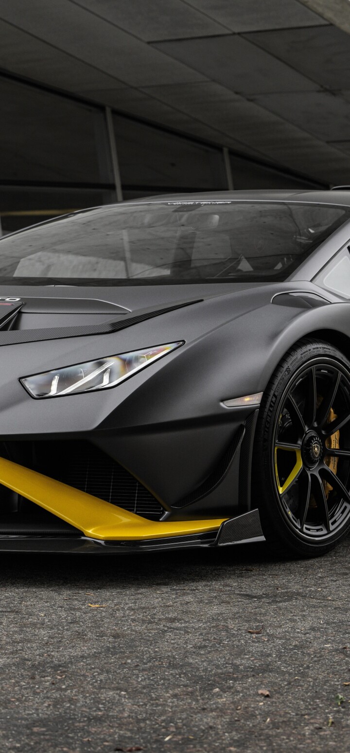 A high-resolution, close-up shot of a matte-finished Lamborghini Huracán STO supercar showcasing its aerodynamic bodywork.