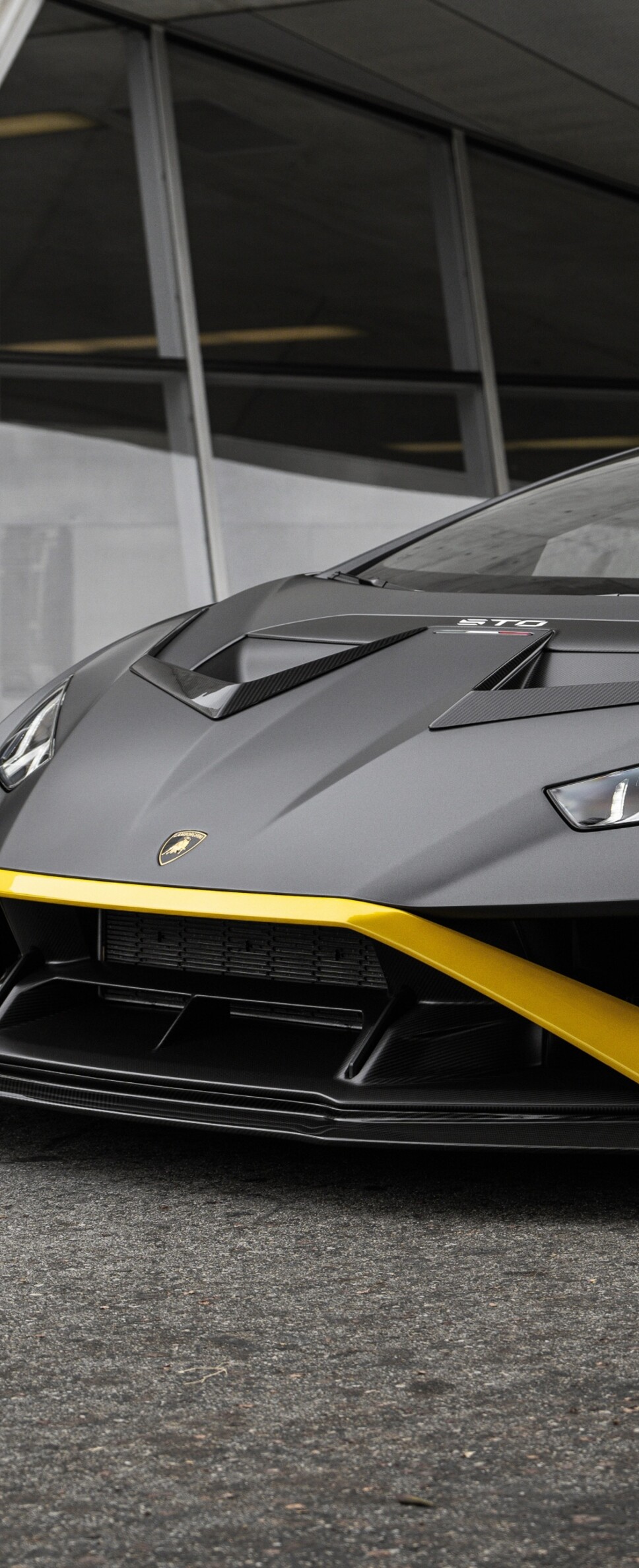A detailed, high-resolution view of a matte-finished Lamborghini Huracán STO emphasizing its aerodynamic design.