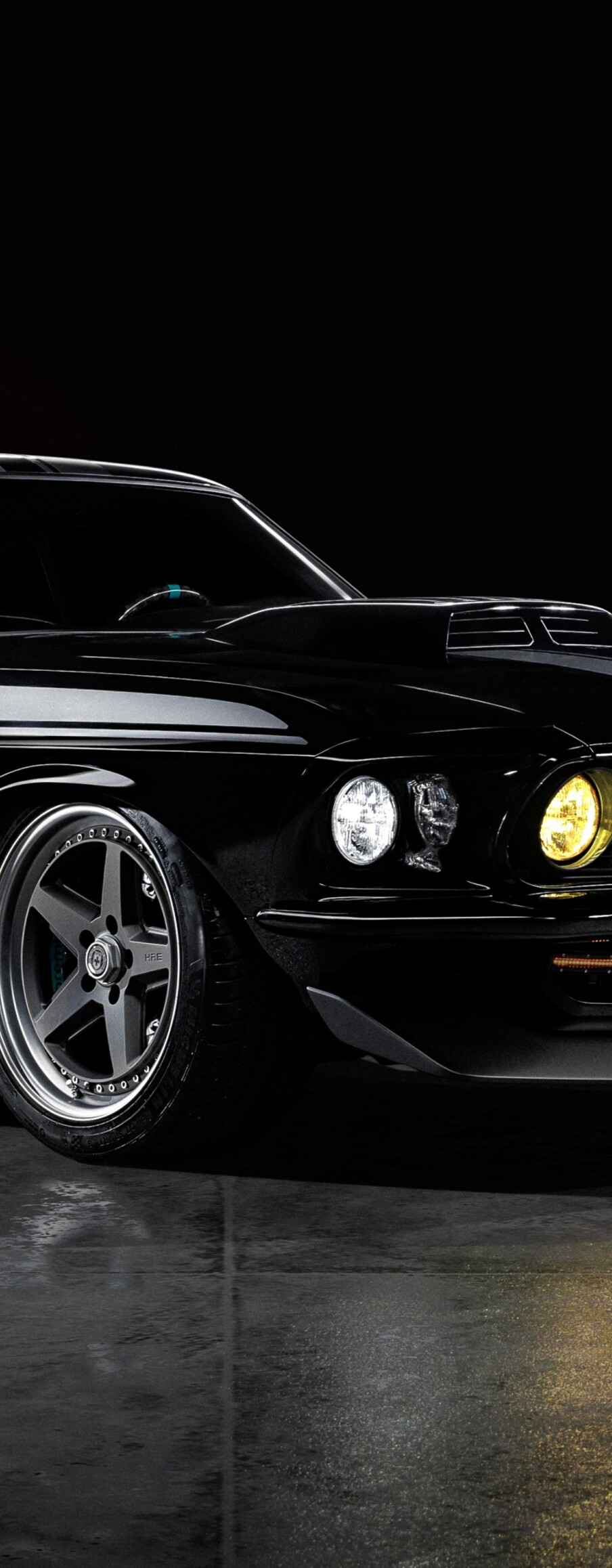 A sleek, glossy black Ford Mustang Mach 1 positioned against a dark, atmospheric background.