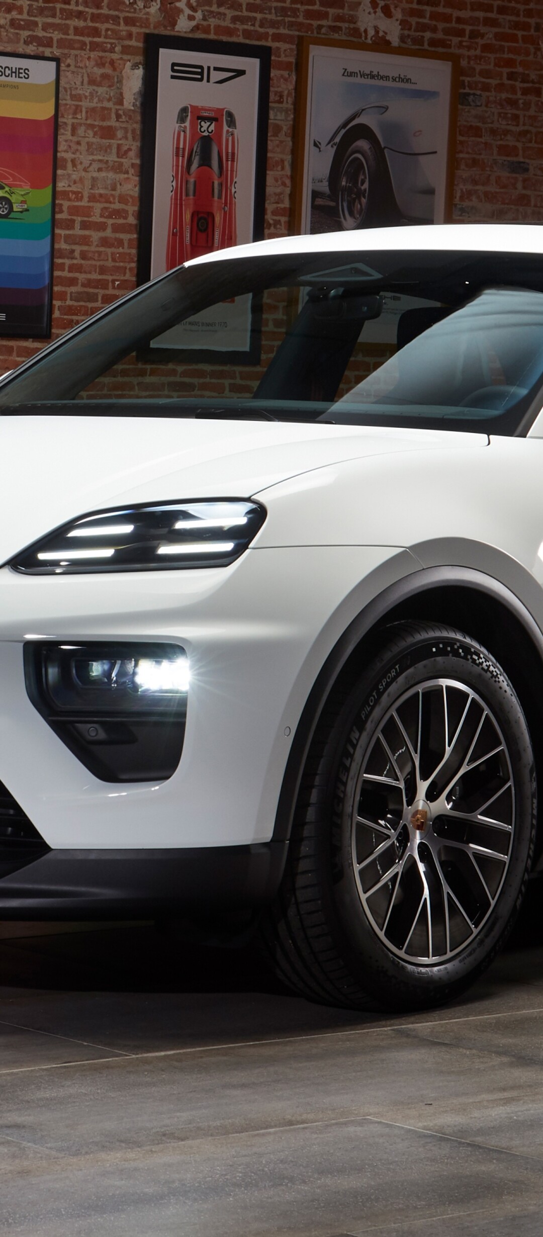 A group of sleek, modern white cars arranged in a high-tech, futuristic setting.