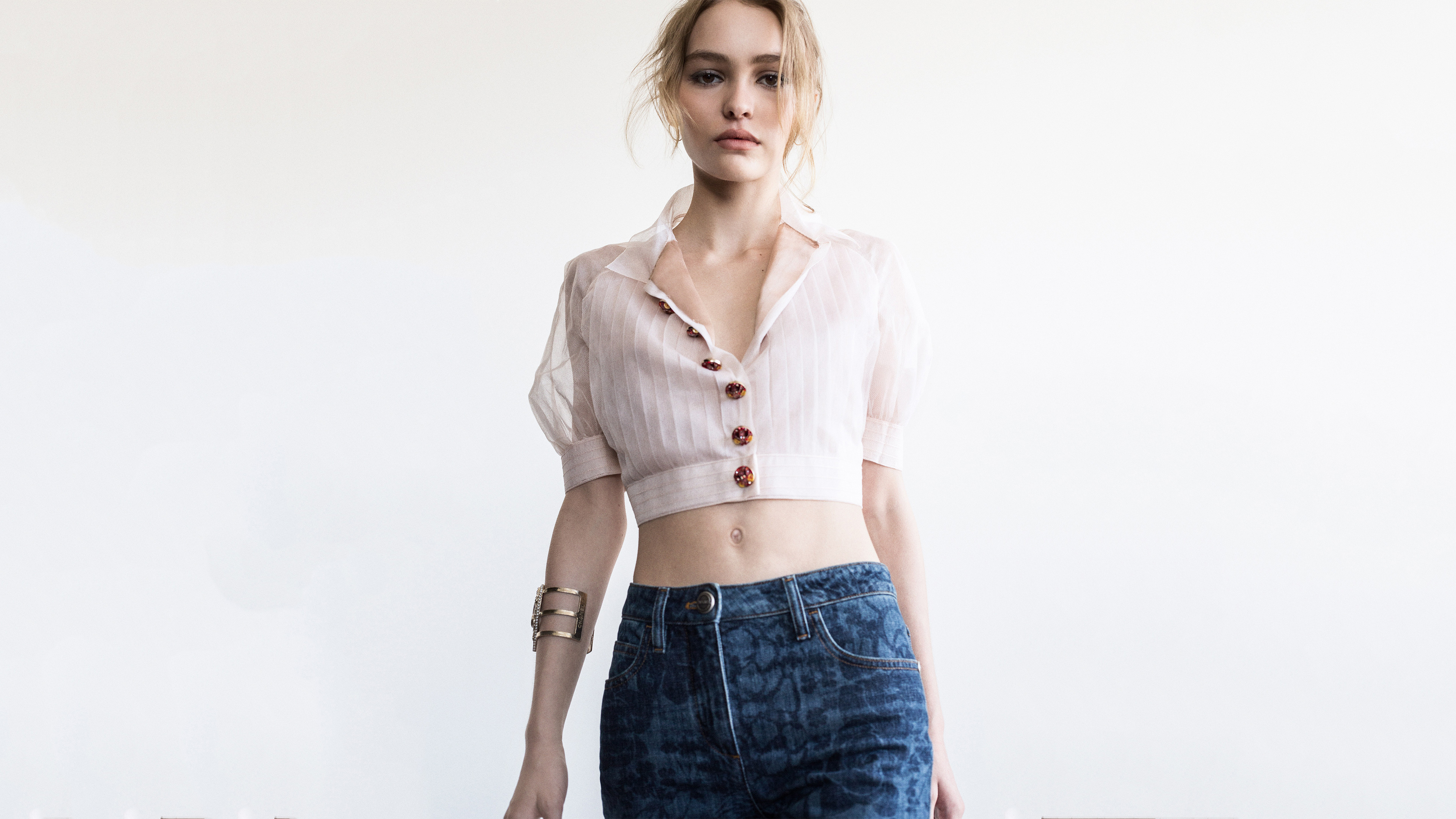 A professional studio portrait of American actress Lily Rose Depp on a solid white background.