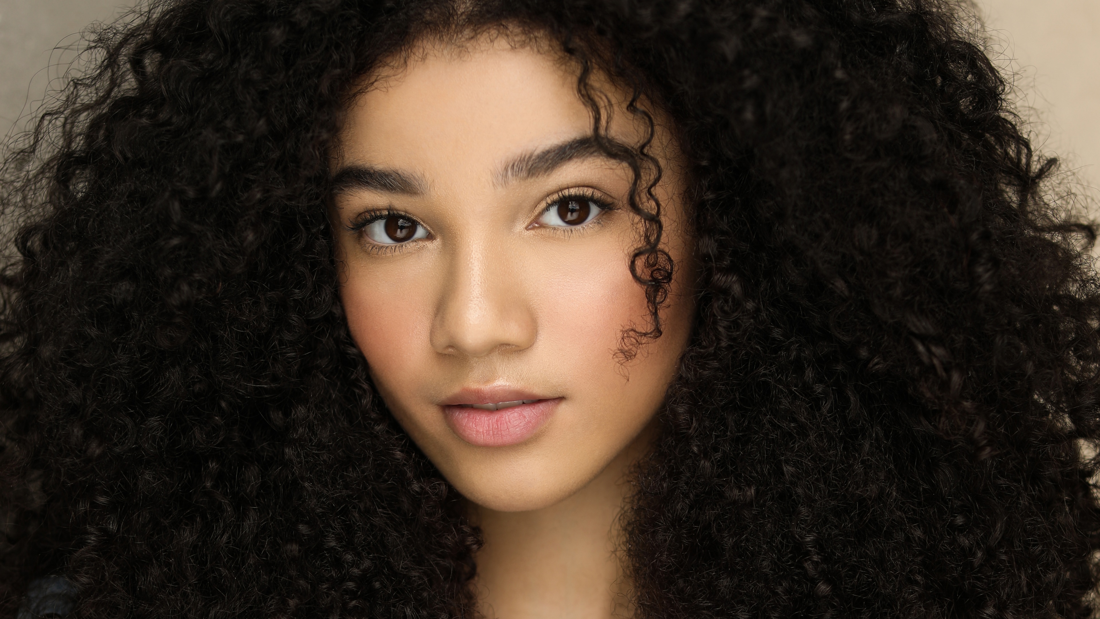 A close-up, high-detail portrait of actress Malia Baker looking directly at the camera.