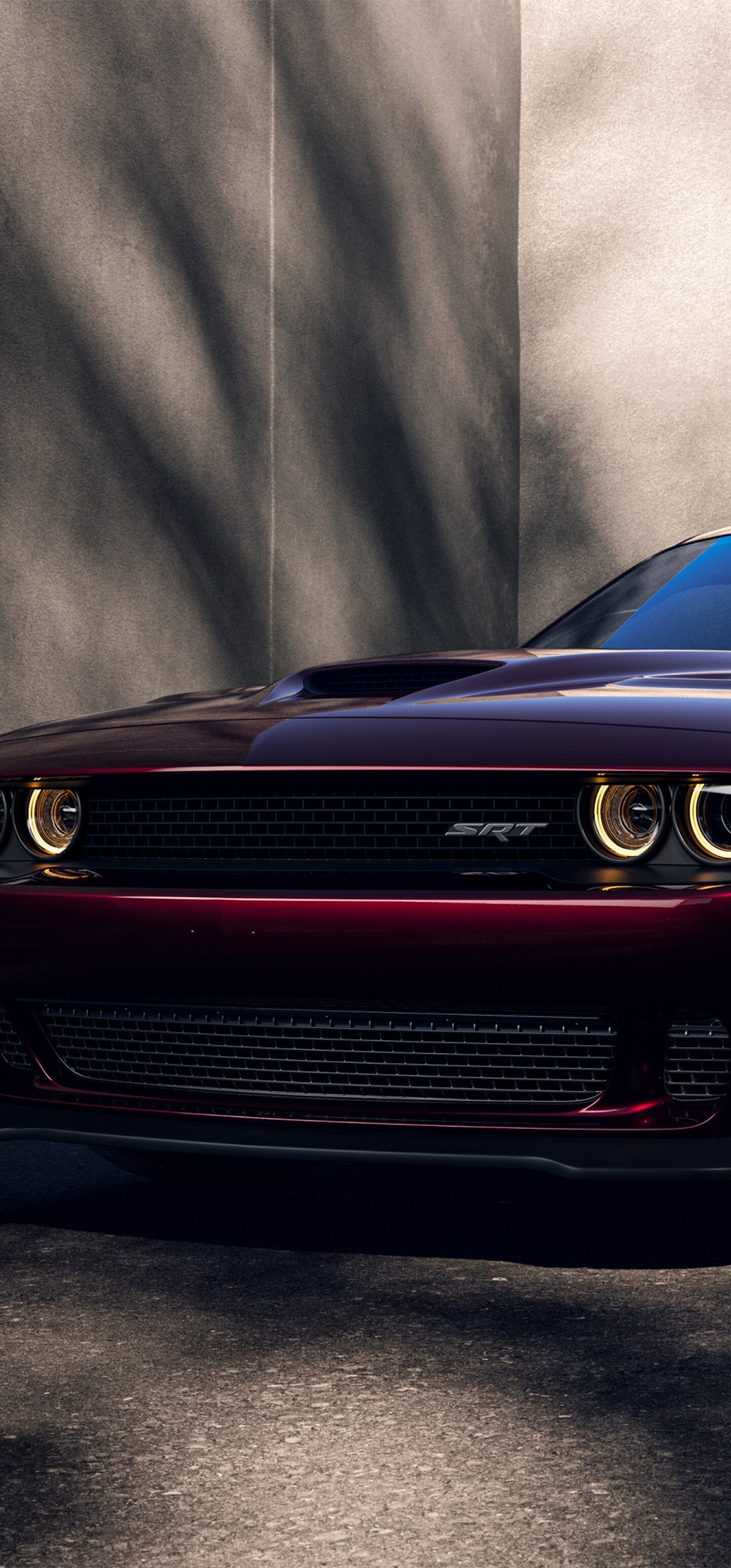 A high-resolution, detailed shot of a bright red Dodge Challenger SRT Hellcat muscle car.