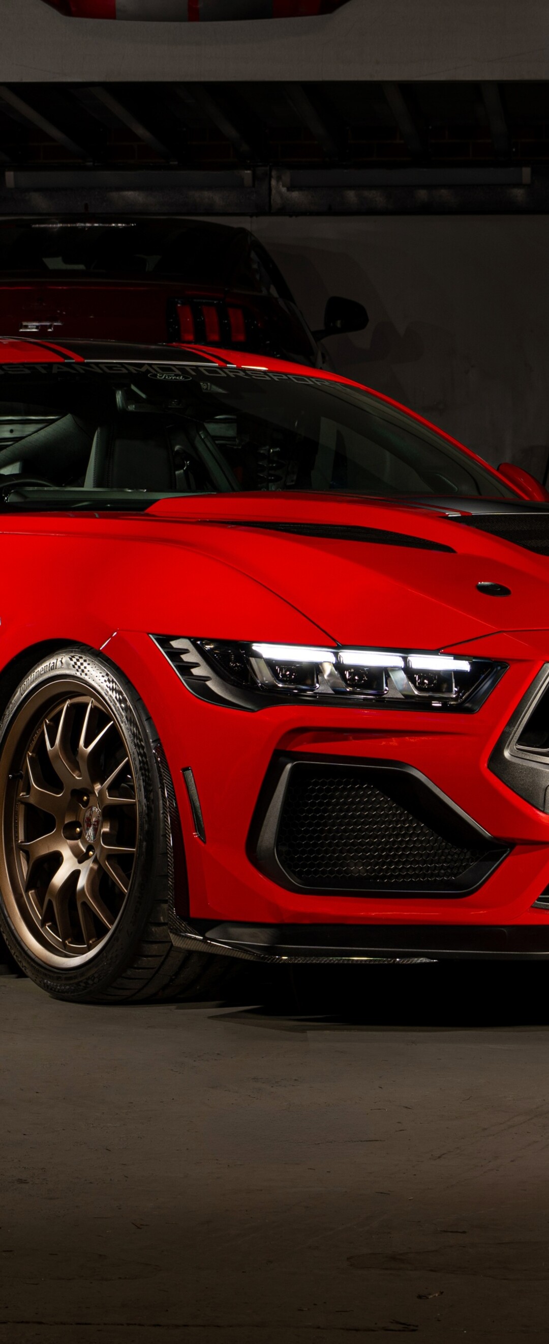 A high-detail shot of a vibrant red Ford Mustang Shelby Super Snake muscle car.