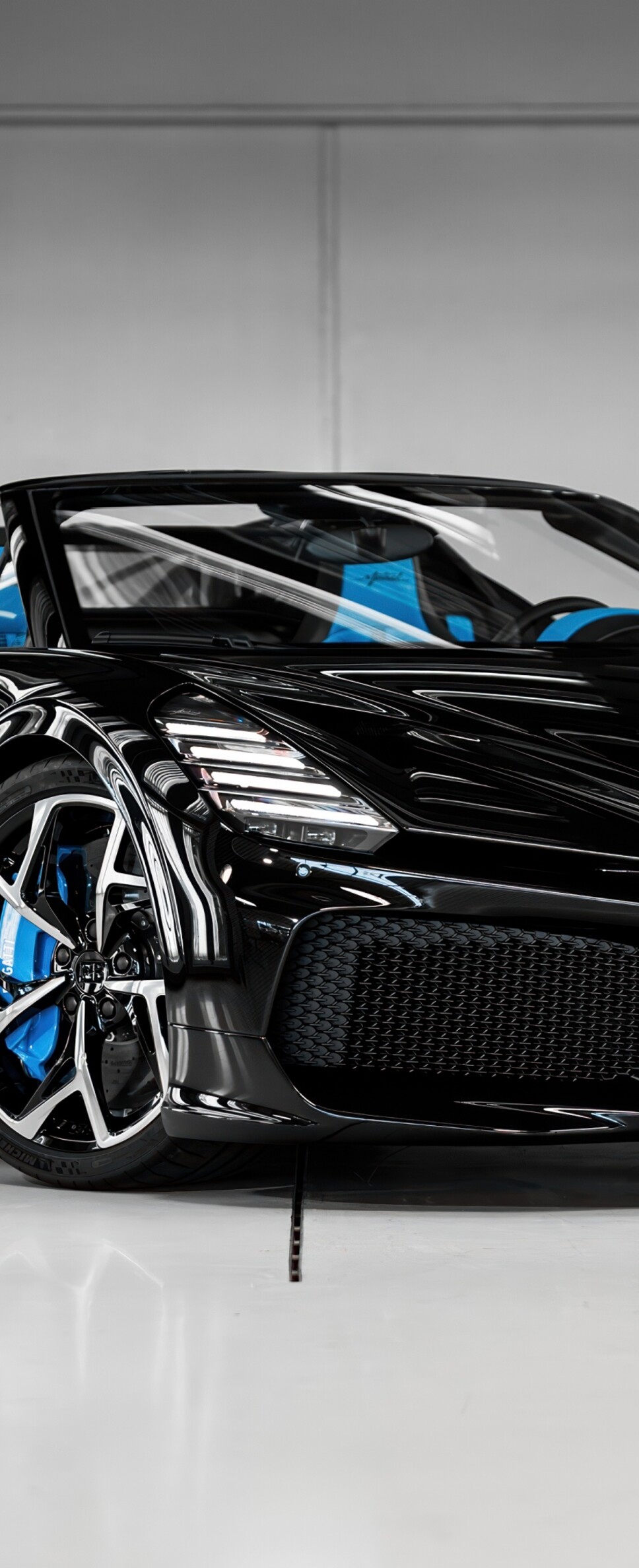 A high-resolution shot of a black Bugatti W16 Mistral roadster hypercar.