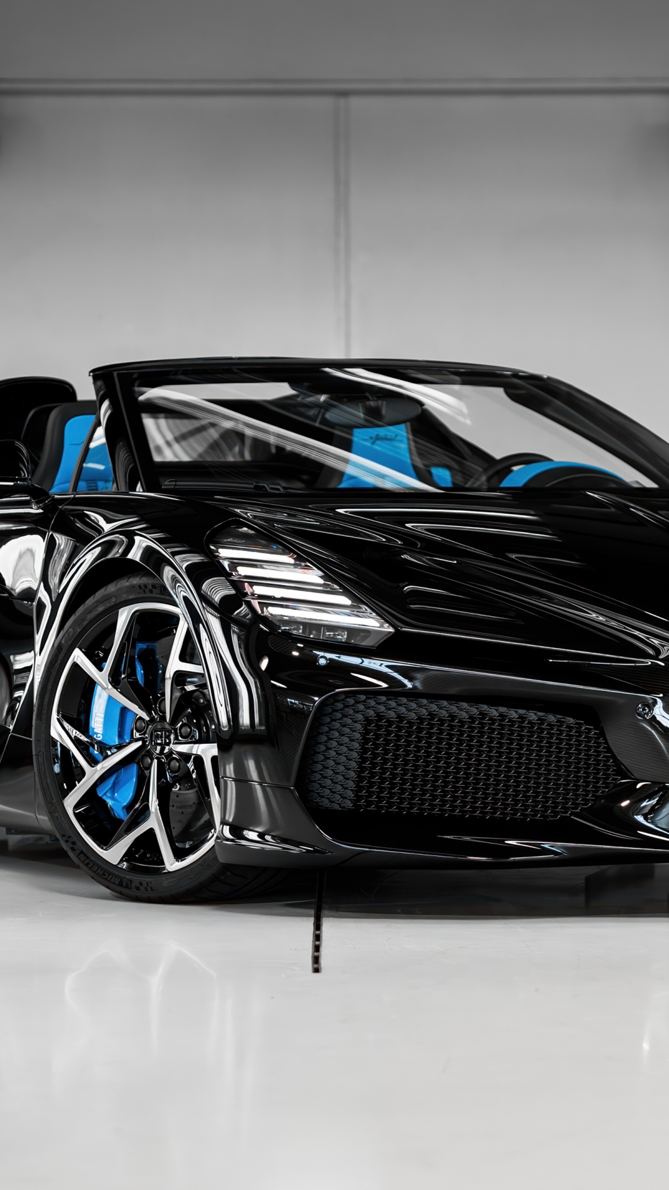 A high-resolution shot of a black Bugatti W16 Mistral roadster hypercar.
