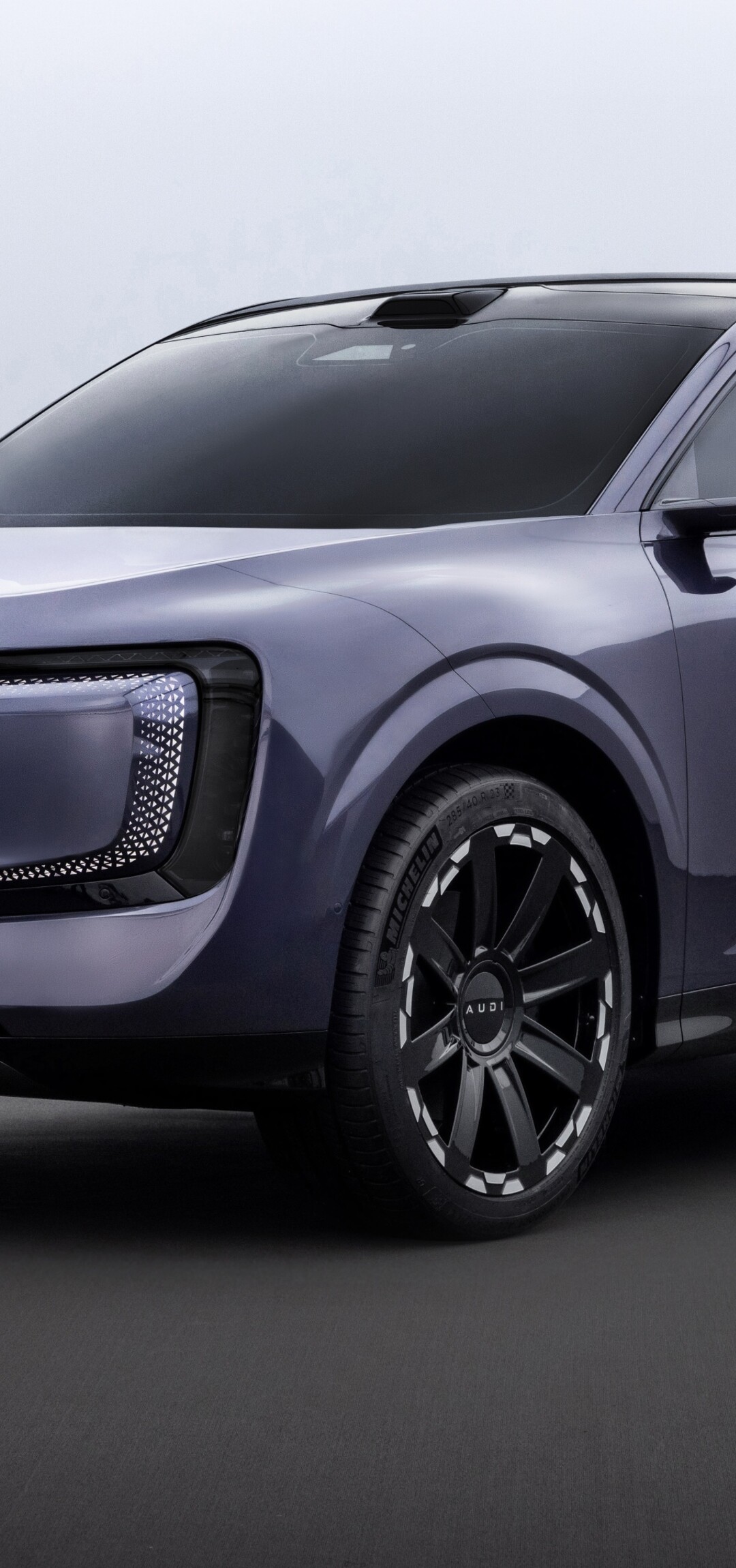 A futuristic 2025 concept car with a sleek, aerodynamic metallic body and advanced LED headlights.