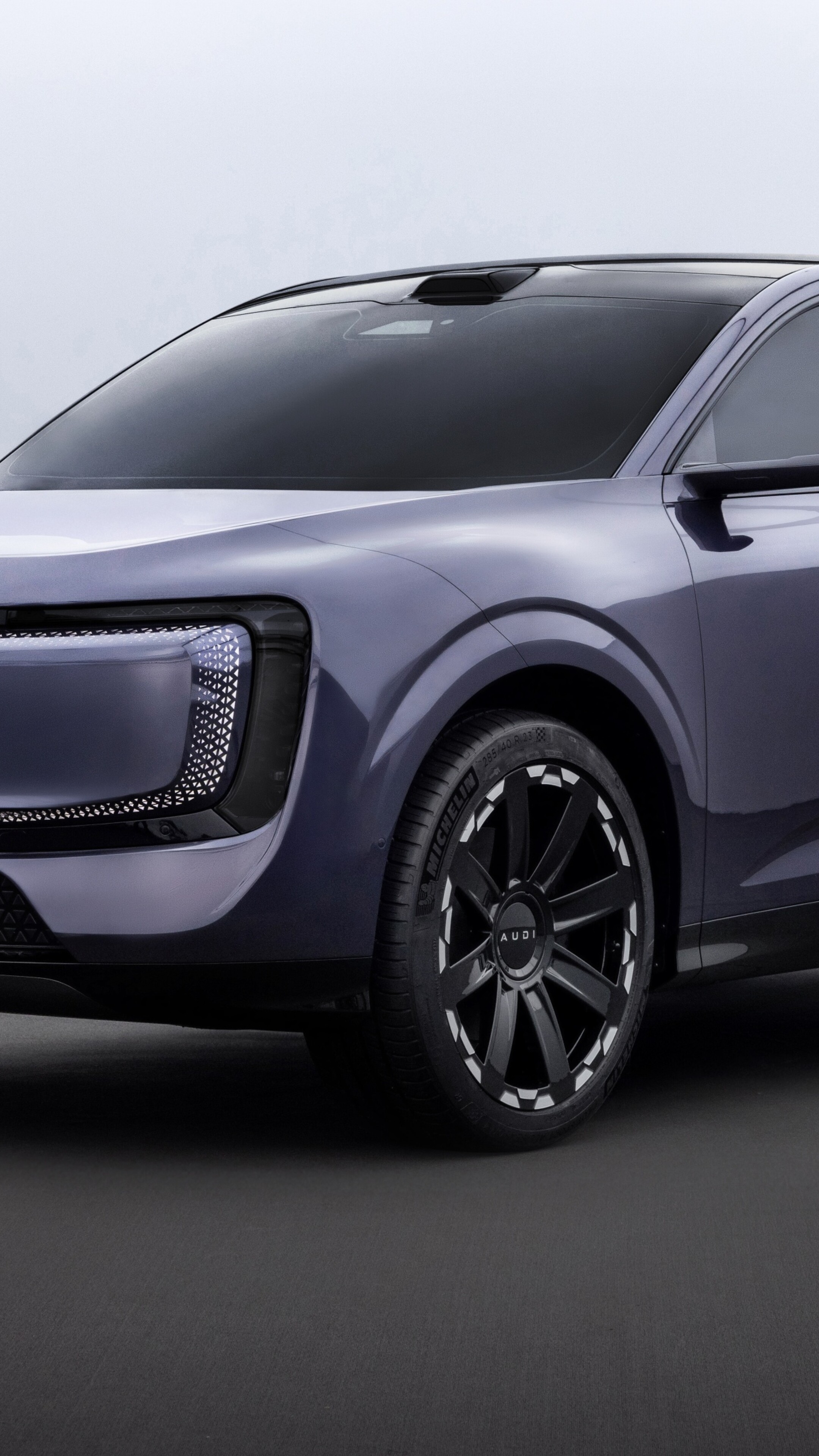A futuristic 2025 concept car with a sleek, aerodynamic metallic body and advanced LED headlights.