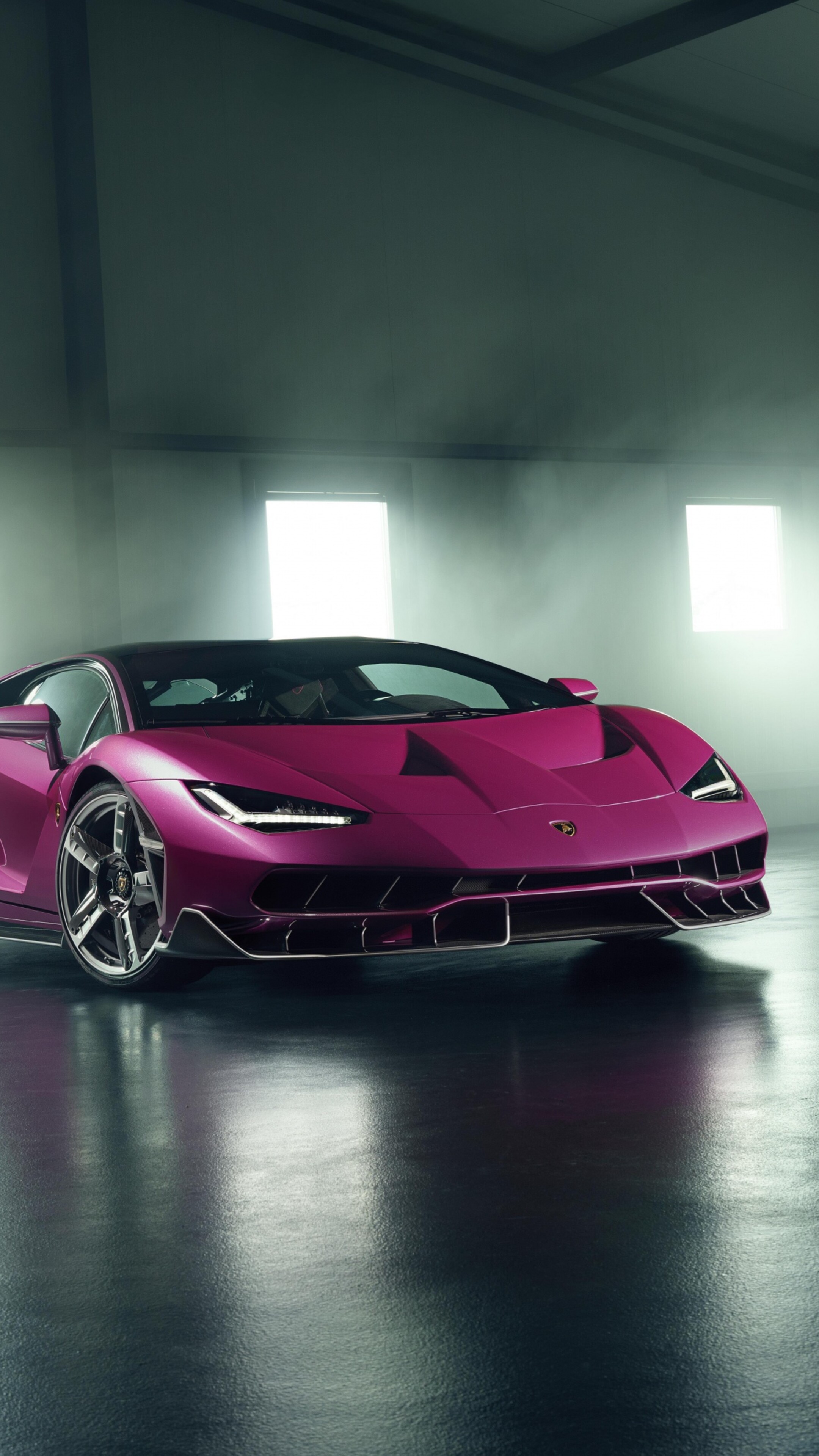 A detailed, high-resolution view of a Lamborghini Centenario parked in a modern, luxury garage setting.