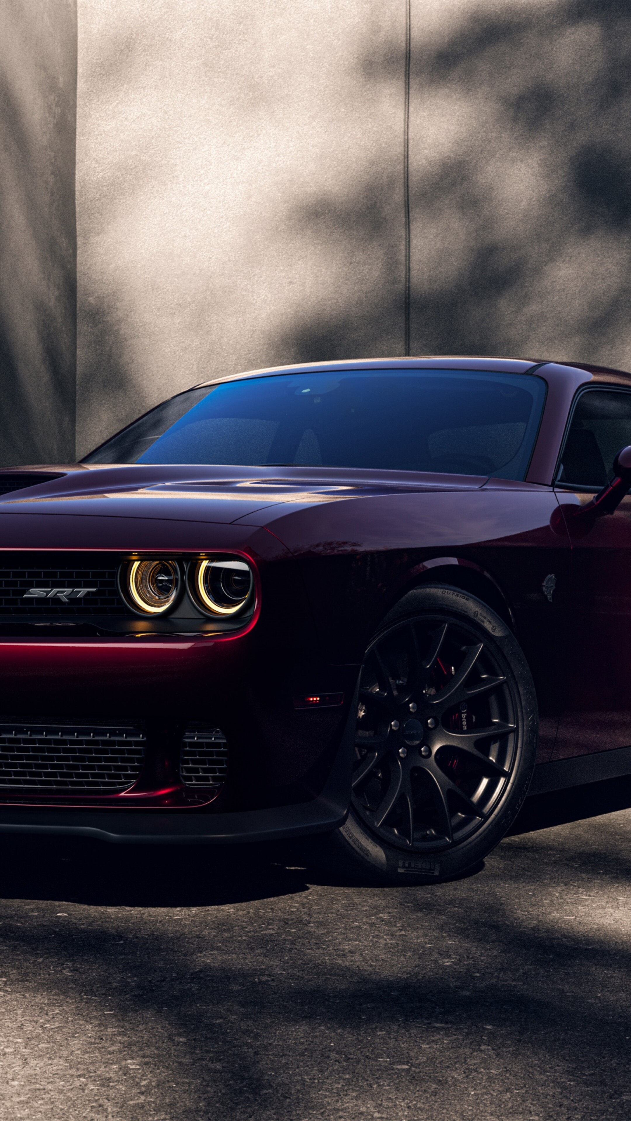 A high-resolution 5K shot of a bright red Dodge Challenger SRT Hellcat muscle car.