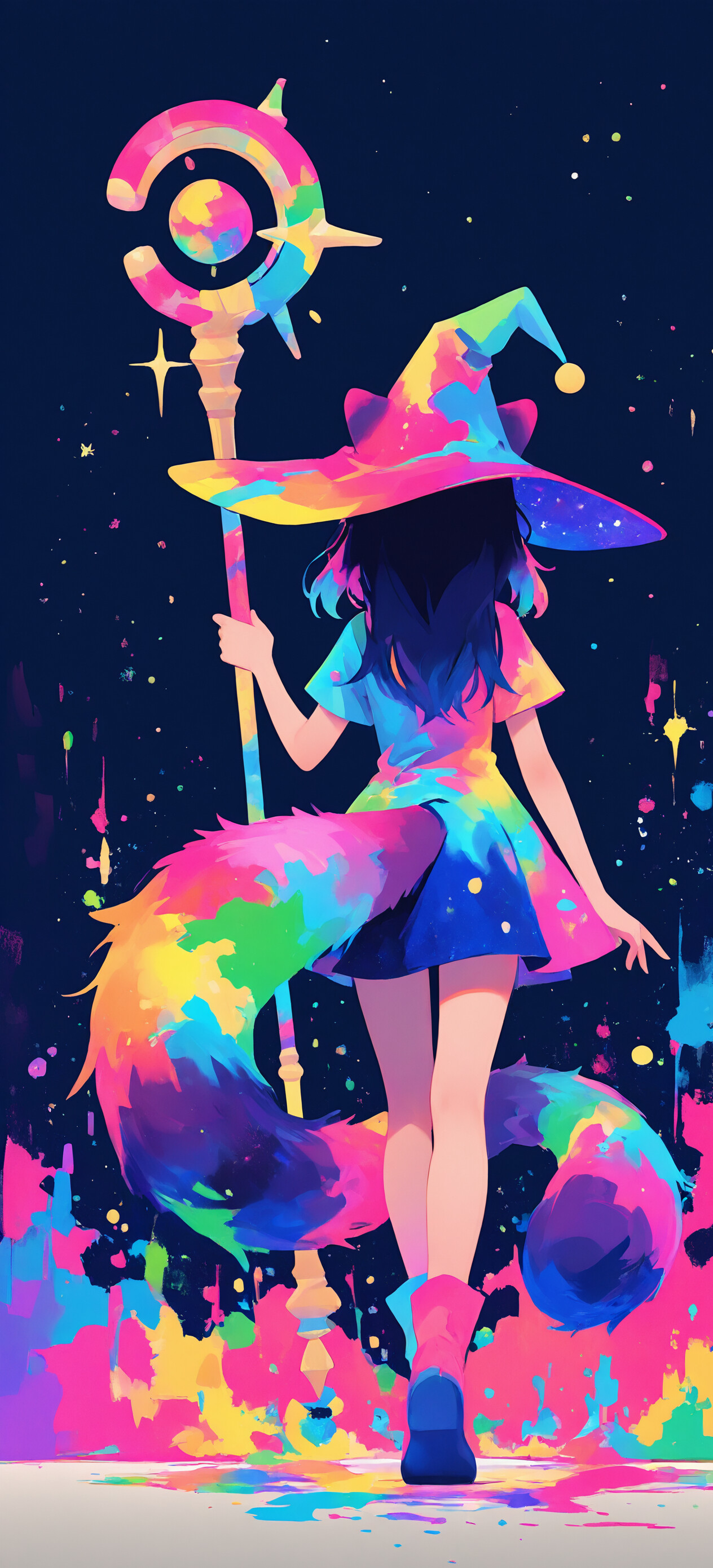 A full-body illustration of a young anime-style witch with dark hair and animal ears. She wears a multicolored rainbow cape and a pointed wizard hat, and holds a magical staff. She stands against a dark, starry background with large, vibrant splashes of rainbow-colored energy.